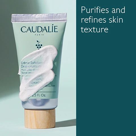 Image 1 - A tube of Caudalie exfoliating cream with a wooden cap is shown with a dollop of cream on it, next to text that reads Purifies and refines skin texture.
Image 2 - A green tube of CAUDALIE exfoliating cream is shown alongside green grapes, mint leaves, and a smear of the cream, with text indicating that it contains volcanic sand microbeads, organic menthol, and organic grape water, along with product volume information.
Image 3 - Image shows two skincare product tubes side by side: on the left, a mint green tube labeled Deep Cleansing Exfoliator which states it deeply purifies with volcanic sand microbeads for all skin types, and on the right, a dark green tube labeled Buffing Cream which states it gently purifies with jojoba microbeads for sensitive skin.
Image 4 - A person holding a tube of Caudalie exfoliating cream, with a small amount of cream on their hand, against a pale green background; the visible text reads Apply to damp skin 1-2 times a week.