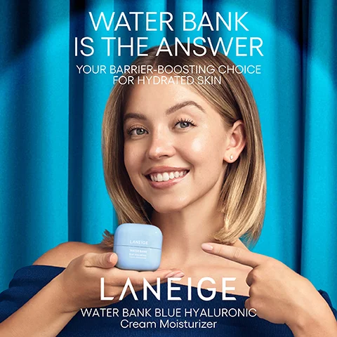A smiling blonde woman in a blue top holds a light blue jar of Laneige Water Bank cream and points to her chest, against a blue curtain backdrop, with the text WATER BANK IS THE ANSWER YOUR BARRIER-BOOSTING CHOICE FOR HYDRATED SKIN, LANEIGE, and WATER BANK BLUE HYALURONIC Cream Moisturizer visible.