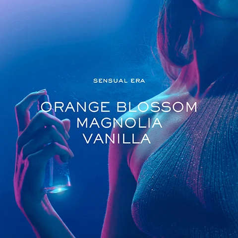 A person holding a spray bottle is featured against a blue and purple background, with the text reading SENSUAL ERA above and ORANGE BLOSSOM MAGNOLIA VANILLA below.